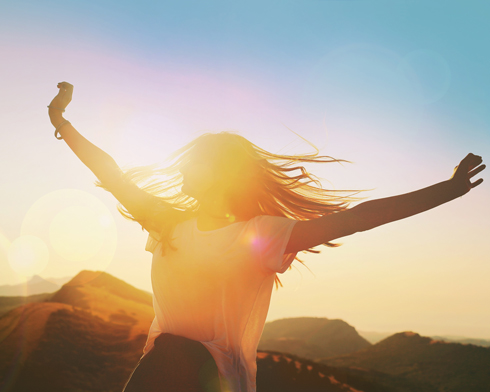 Happy woman outside in sunshine