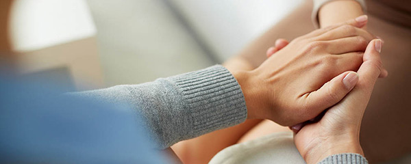 Close up people holding hands