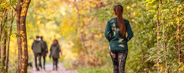 Woman jogging through forest